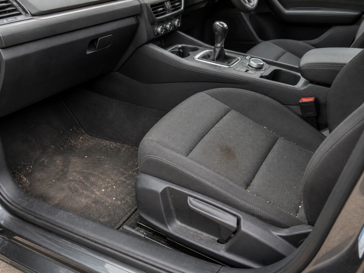 Demonstration image of a car interior before cleaning